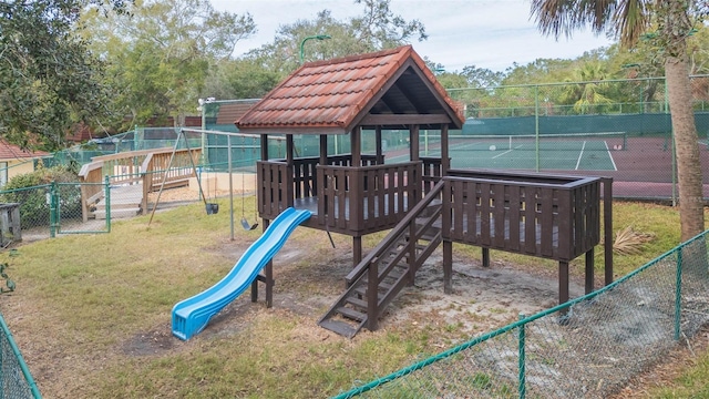 view of jungle gym with a yard and tennis court