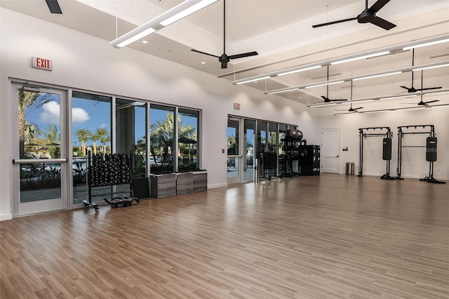 interior space with a towering ceiling and hardwood / wood-style flooring