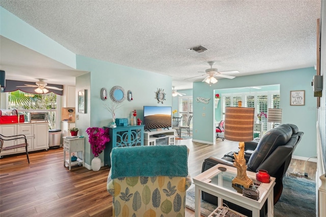 living room featuring a textured ceiling and hardwood / wood-style flooring