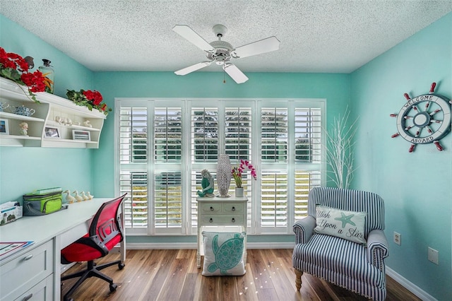 office space with ceiling fan, wood-type flooring, and a textured ceiling