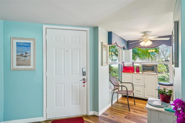 foyer entrance with light wood-type flooring and ceiling fan