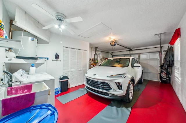 garage with washing machine and clothes dryer, ceiling fan, sink, and a garage door opener