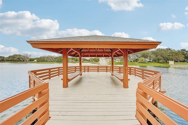 view of dock featuring a gazebo and a water view