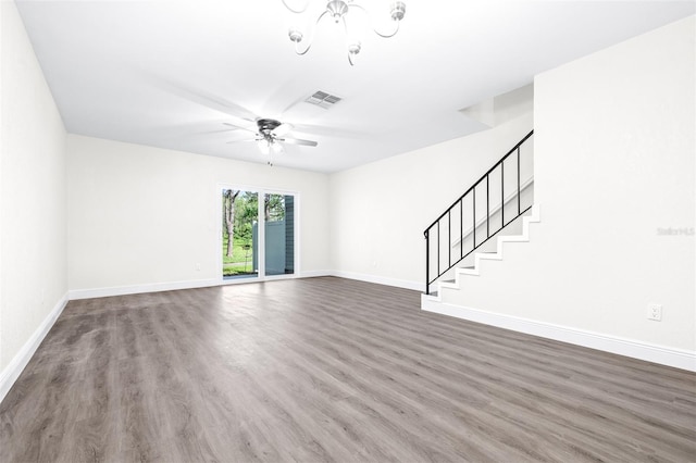 unfurnished living room with ceiling fan and dark hardwood / wood-style flooring