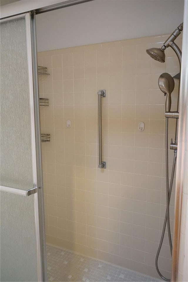 bathroom featuring a shower with shower door