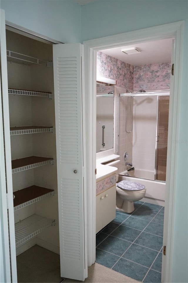 full bathroom with tile patterned flooring, shower / bathing tub combination, vanity, and toilet