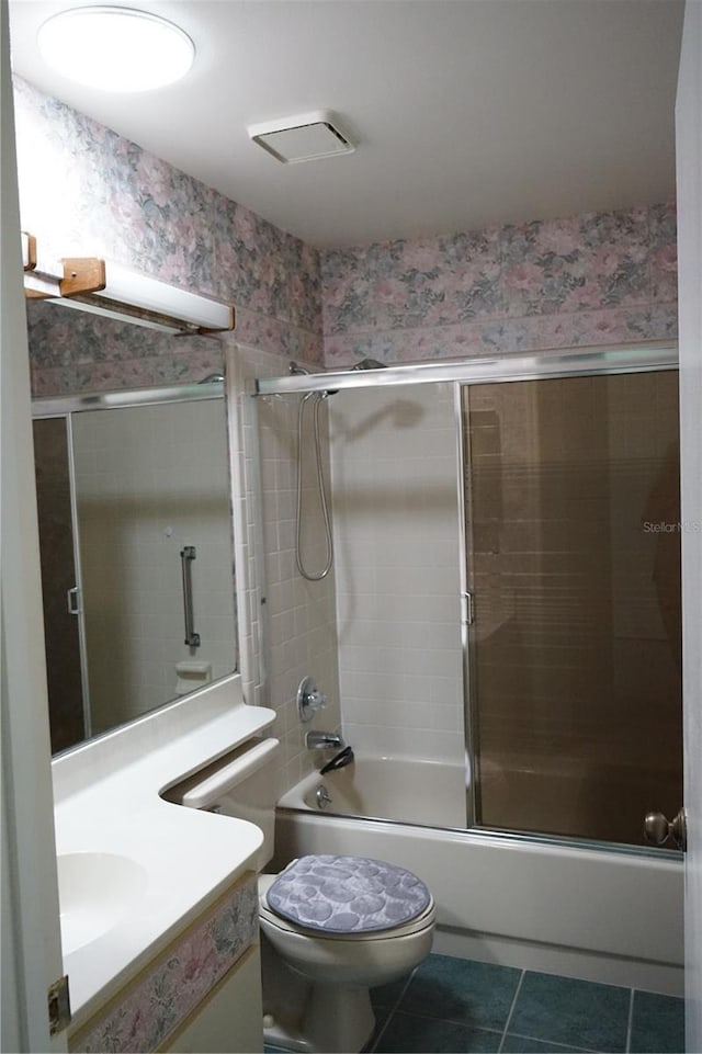 full bathroom with tile patterned flooring, vanity, enclosed tub / shower combo, and toilet