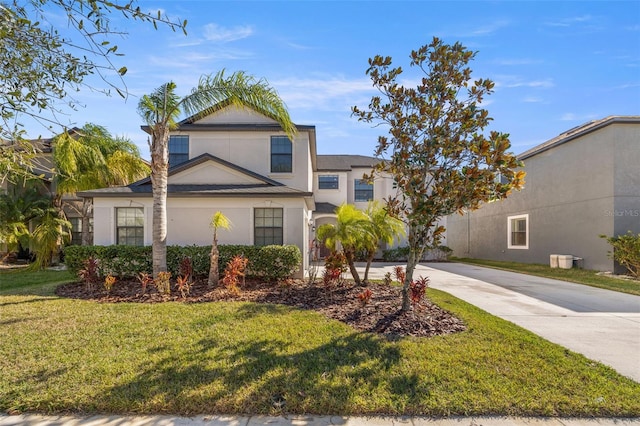 view of property featuring a front lawn