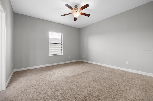 carpeted spare room featuring ceiling fan