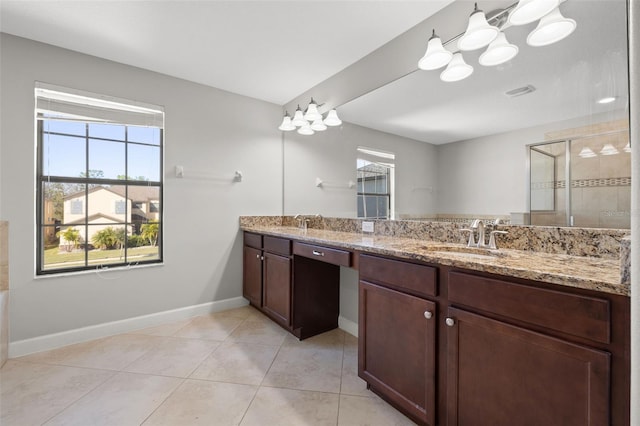 bathroom featuring tile patterned flooring, vanity, and an enclosed shower