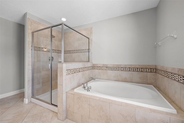 bathroom with tile patterned flooring, a textured ceiling, and plus walk in shower