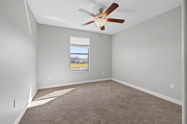 unfurnished room featuring ceiling fan and carpet floors