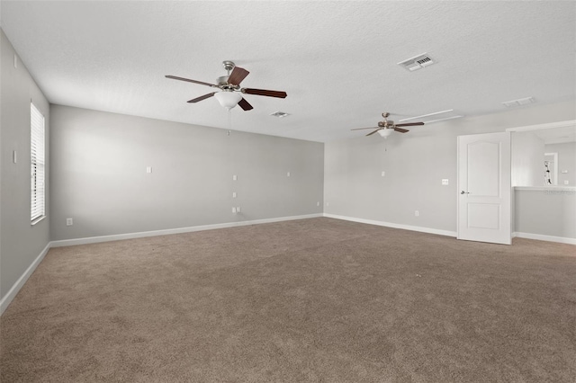 spare room featuring ceiling fan, carpet floors, and a textured ceiling