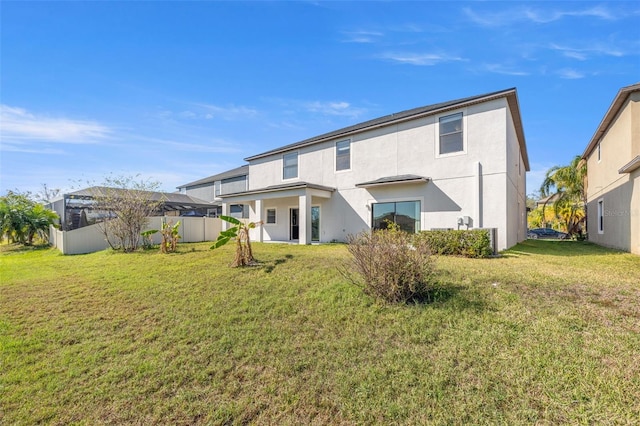 rear view of property featuring a yard