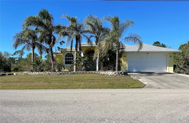 view of front facade with a front yard and a garage