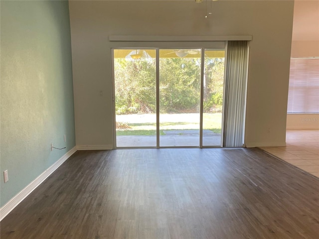 empty room with a healthy amount of sunlight and hardwood / wood-style flooring