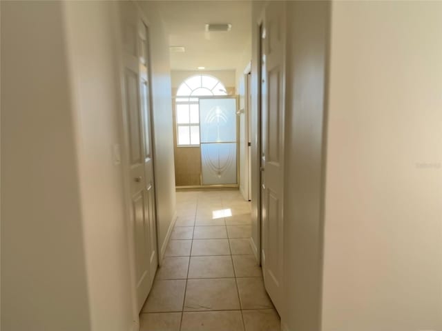 corridor featuring light tile patterned floors