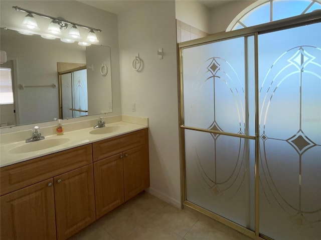 bathroom featuring tile patterned flooring, plenty of natural light, walk in shower, and vanity