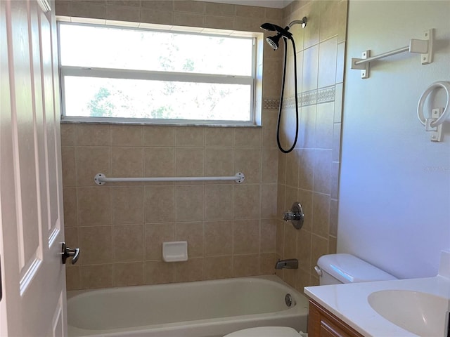 full bathroom with vanity, toilet, tiled shower / bath, and a wealth of natural light