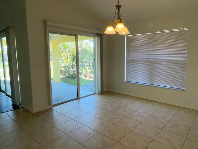 unfurnished dining area featuring light tile patterned flooring and a chandelier