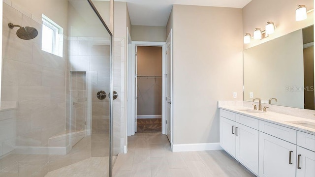 bathroom with vanity and a shower with door