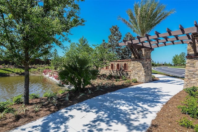 community / neighborhood sign featuring a water view