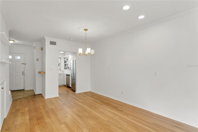 unfurnished dining area featuring ornamental molding, a notable chandelier, and light wood-type flooring