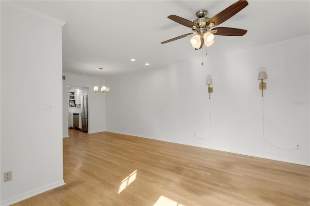 unfurnished room with ornamental molding, ceiling fan with notable chandelier, and light hardwood / wood-style floors