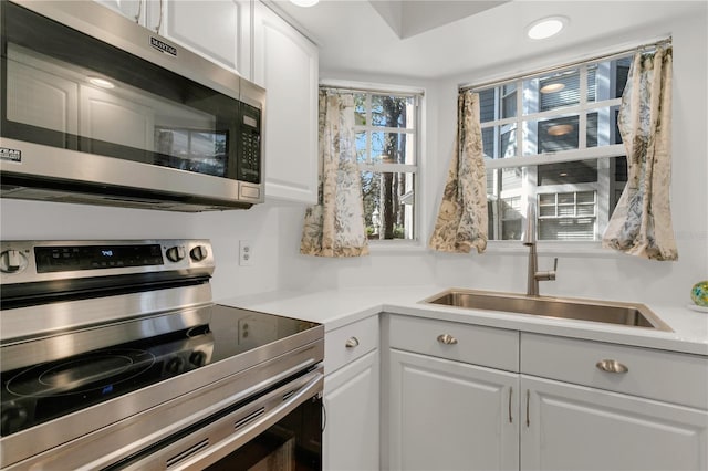 kitchen featuring white cabinetry, appliances with stainless steel finishes, and sink