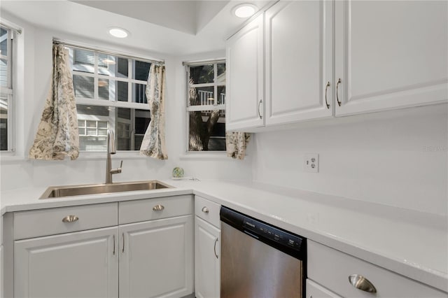 kitchen featuring white cabinetry, sink, and dishwasher