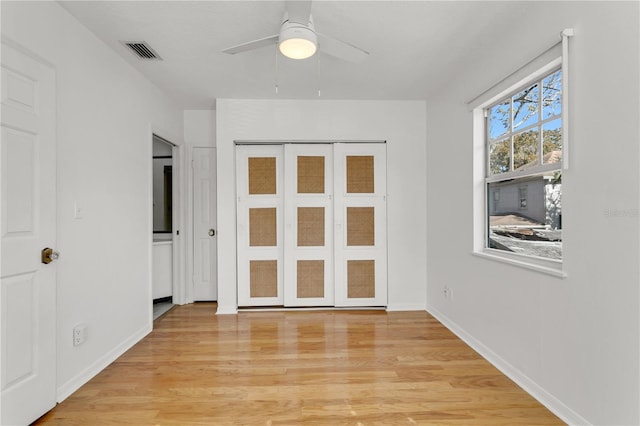 interior space with ceiling fan and light hardwood / wood-style floors