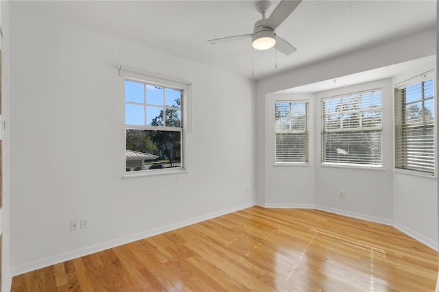 empty room with ceiling fan and wood-type flooring