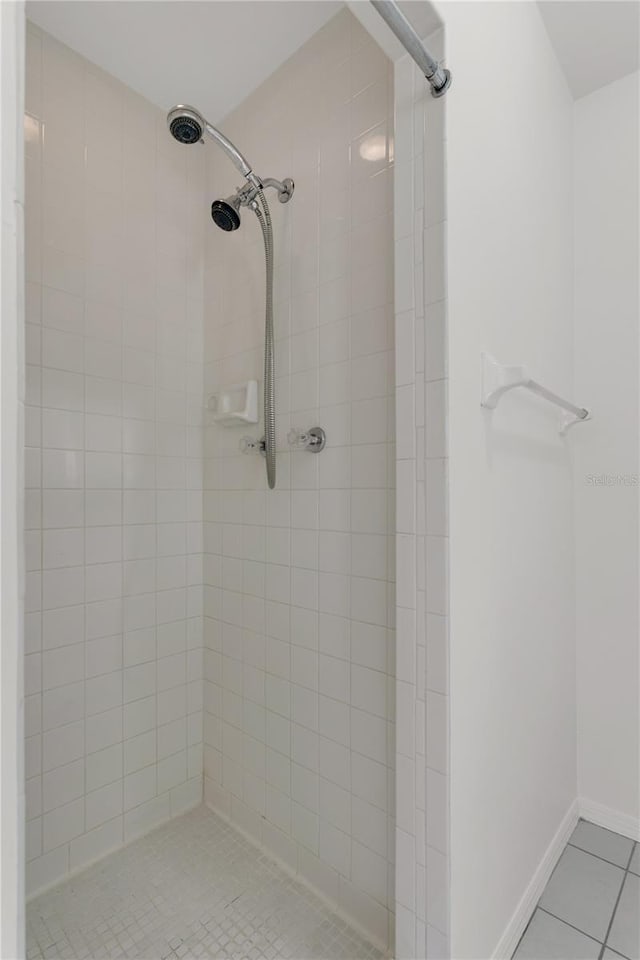 bathroom featuring a tile shower and tile patterned floors