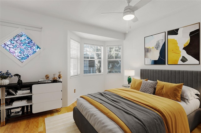 bedroom featuring light wood-type flooring and ceiling fan