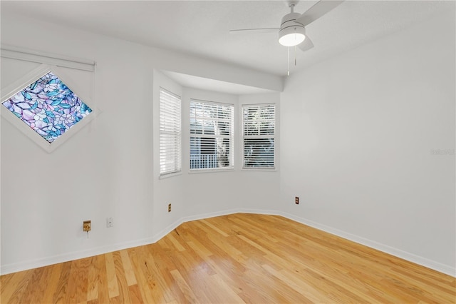 empty room featuring wood-type flooring and ceiling fan