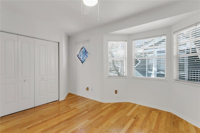 unfurnished bedroom with hardwood / wood-style flooring and a closet