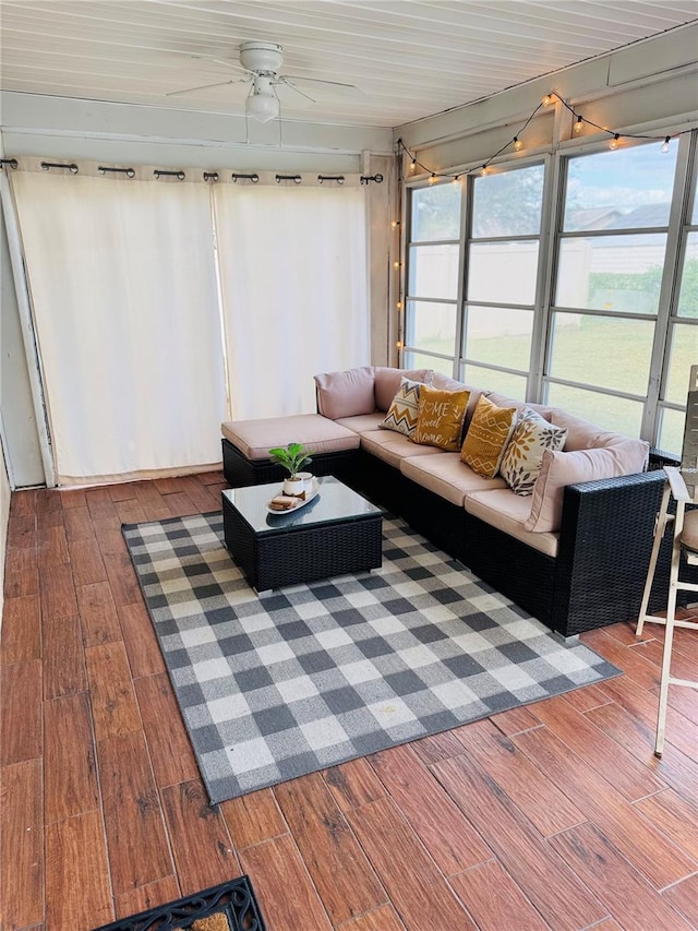 living room with hardwood / wood-style flooring and ceiling fan