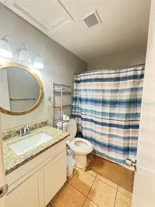 bathroom featuring toilet, vanity, tile patterned floors, and curtained shower