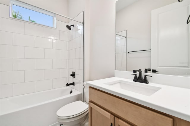 full bathroom with toilet, vanity, and tiled shower / bath