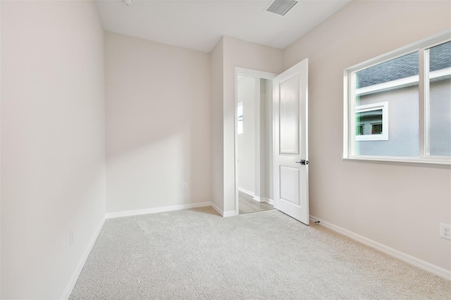 unfurnished bedroom with light colored carpet