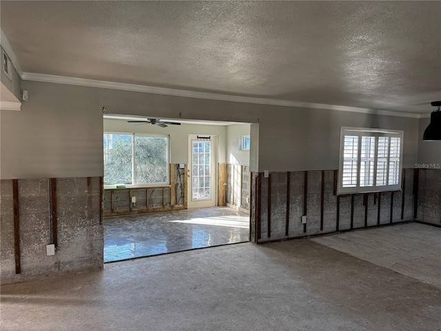 interior space featuring ceiling fan, crown molding, and a textured ceiling