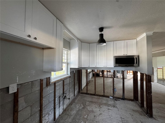 kitchen featuring white cabinets and a textured ceiling