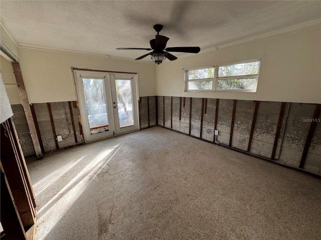 spare room with french doors, a textured ceiling, ceiling fan, and ornamental molding