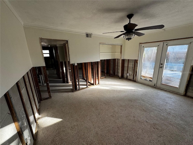 spare room featuring french doors, a textured ceiling, and ceiling fan