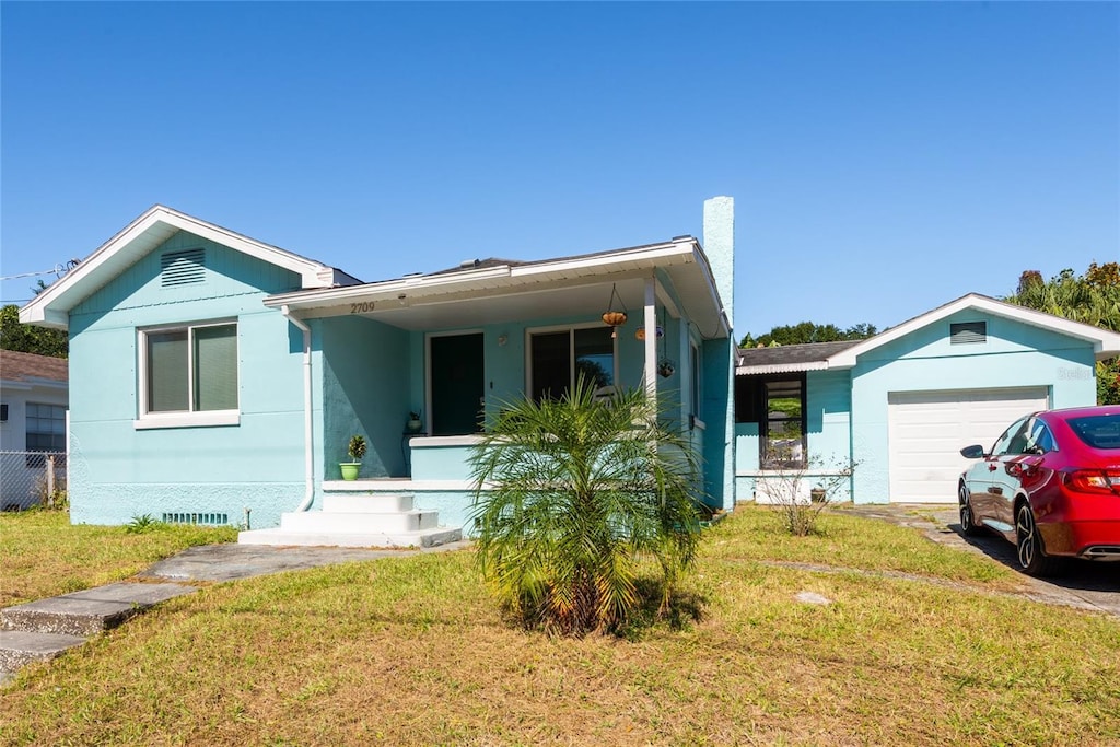 view of front of property with a garage and a front lawn