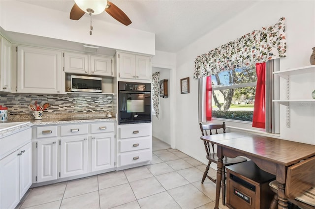 kitchen with white cabinetry, ceiling fan, tasteful backsplash, oven, and light tile patterned flooring