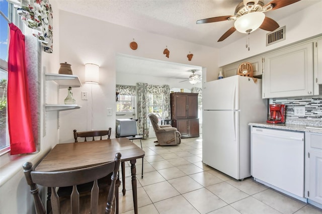 kitchen featuring white cabinetry, ceiling fan, backsplash, white appliances, and light tile patterned floors