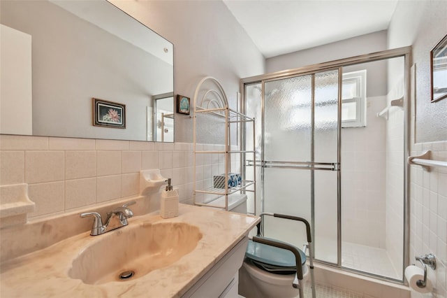 bathroom with vanity, toilet, and a shower with shower door