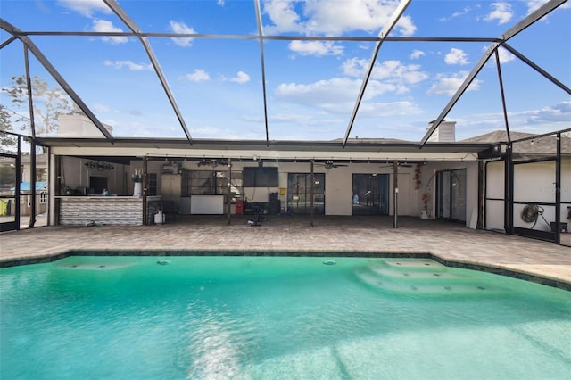 view of pool with ceiling fan, a patio, and glass enclosure