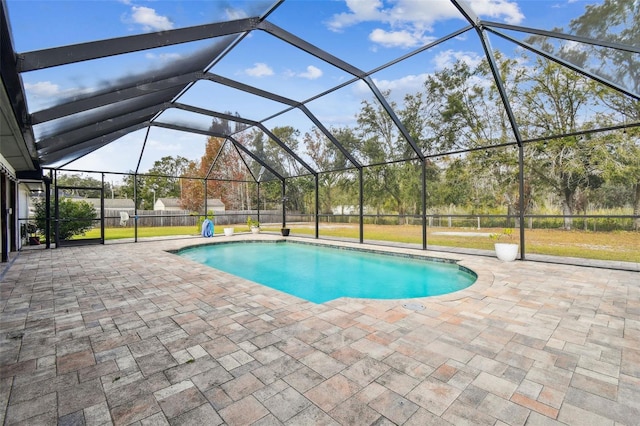 view of swimming pool with a patio area and a lanai